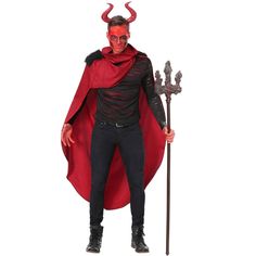 a man dressed in devil costume and holding a staff