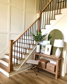 a wooden table sitting under a banister next to a stair case