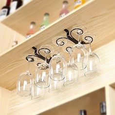 there are many wine glasses on the shelf