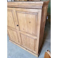 a wooden cabinet sitting on top of a floor