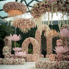 an elaborate floral display with chandeliers and flowers in the shape of numbers on top