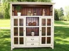 an old china cabinet with glass doors and shelves on the front is shown for sale