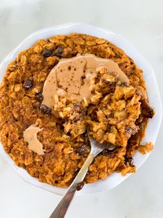 a white plate topped with oatmeal and peanut butter