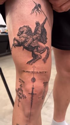 a man with a tattoo on his leg that has an image of a horse and compass