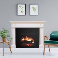 a living room with a fire place and two framed pictures on the wall above it