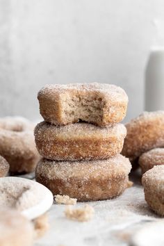 a stack of doughnuts sitting on top of each other next to a cup