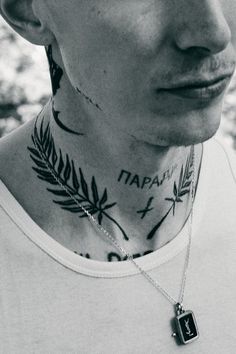 a man with tattoos on his neck and chest