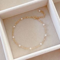 * DETAILS* This dainty bracelet is a perfect gift to the one you love or to yourself. A nice every day bracelet. - Swarovski Crystal Pearl Beads 3mm - 24k Gold Filled Chain - 14K GOLD FILLED Wire - 14k Gold Filled Spring Ring Clasp ✨ All components are 14k Gold Filled. 👉🏻For more pearl bracelets, see https://www.etsy.com/shop/JinnysJewelryBySeJin 🌟You may also like Blue Topaz Bracelet. Here is the link. https://www.etsy.com/JinnysJewelryBySeJin/listing/1088450006/london-blue-topaz-14k-gold-fi Affordable Round Pearl Bracelet For Birthday, Gold Bracelet With Pearls, Swarovski Bracelet Gold, Elegant Hypoallergenic Beaded Bracelets For Anniversary, Elegant Beaded Birthstone Bracelets, Elegant Gold Crystal Bracelet With Birthstone, Elegant Gold Crystal Birthstone Bracelet, Delicate Pearl Chain Bracelet For Anniversary, Classic Gold Crystal Bracelet As Gift