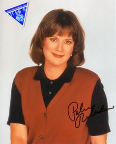 an autographed photo of a woman with brown hair