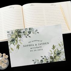 an open wedding book with flowers on it