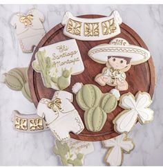 some cookies are laying on a plate with baby's names and other decorations around them