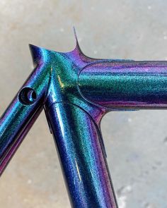 a close up shot of the top end of a bike with colorful paint on it