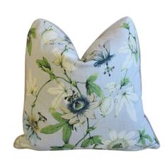 a blue and white pillow with flowers on it