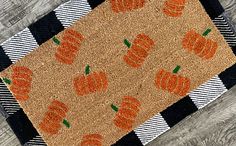 a door mat with orange pumpkins on it