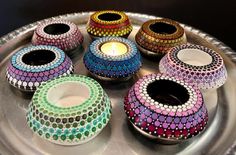 colorful candles are sitting on a silver tray