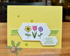 a close up of a card on a table with flowers and polka dotes in the background