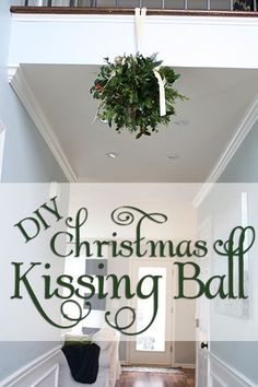 a christmas decoration hanging from the ceiling in a hallway with text overlay that reads diy christmas kissing ball