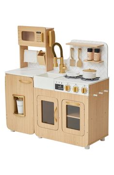 a wooden toy kitchen with an oven and sink