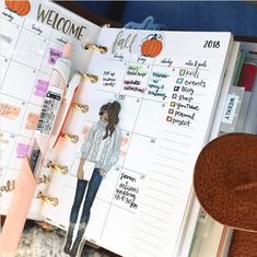 an open planner book sitting on top of a desk next to a pair of shoes