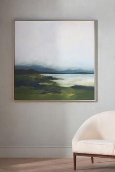 a painting hanging on the wall above a chair