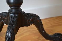 an ornate wooden table with a black top