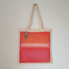 an orange and red bag hanging on the wall