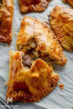 several pastries sitting on top of a piece of wax paper