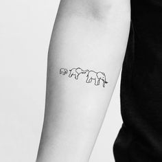 three elephants tattoo on the left inner arm and forearm, in line with each other