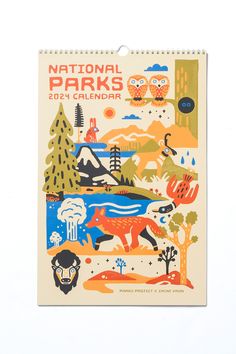 the national parks calendar is displayed on a white surface with trees and animals in it