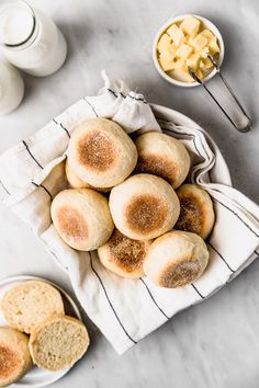 a bag full of rolls next to some bowls of cheese