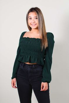 Absolutely adorable top with a ruffled square neckline and long elasticized sleeves. Featuring smocking at back, and a slightly cropped hem is perfect for pairing with high waist bottoms! -Color: Dark Green -Elasticized sleeves -Content: 100% Polyester -Imported -Runs true to size -Model is 5'1" and wearing size Small Trendy Smocked Top With Long Elastic Sleeves, Trendy Long Sleeve Smocked Top With Elastic Sleeves, Casual Smocked Top With Square Neck And Elastic Sleeves, Long Sleeve Smocked Top With Smocked Back, Solid Color Long Sleeve Smocked Top, Solid Long Sleeve Smocked Top, Stretch Smocked Bodice Cropped Top, Trendy Long Sleeve Stretch Smocked Top, Fall Square Neck Smocked Top With Ruched Detail