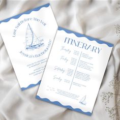 two white and blue wedding stationery with sailboat on it's front and back