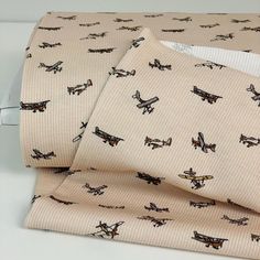 two pieces of cloth with airplanes printed on them