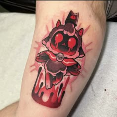 a tattoo on the leg of a man with a red and black ink splattered design