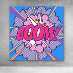 the word boom is painted on a blue background with pink and yellow rays around it