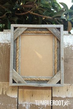 an old wooden frame with rope around it