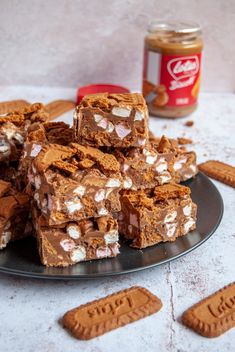 a plate full of cookies and marshmallows next to some peanut butter crackers