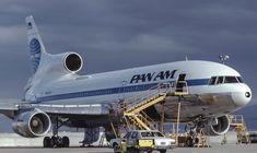 an airplane is parked on the tarmac with stairs leading up to it