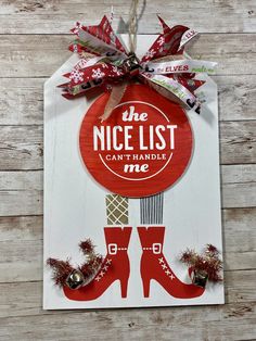 the nice list can handle shoe ornaments on a wooden wall with ribbon and bells hanging from it