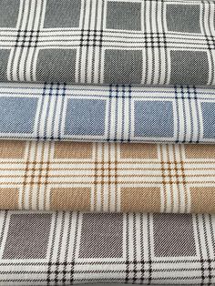 four different plaid fabrics stacked on top of each other