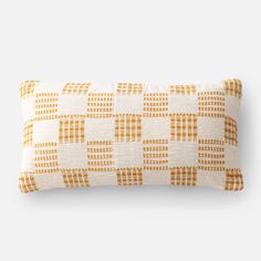 an orange and white checkered pillow on a white background