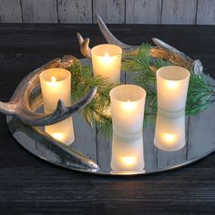 a tray with candles and deer antlers on it