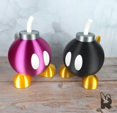 two colorful mickey mouse lamps sitting on top of a wooden table next to each other