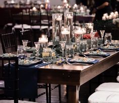 a long table is set with candles and place settings for an elegant dinner or party