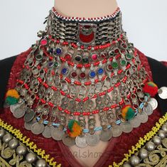 Big Kuchi nomad tribal choker necklace with colorful jewels, coins and dangles held together by six rows of glass seed bead strands. The crescent moon jewel at the upper area are made of a plastic screen put over a colored glittery foil, which is a very traditional way to create jewels in the Kuchi jewelry design. The colorful jewels are made of glass except of four pink jewels. The bottom row is made of real old coins with additional ornations of newly added pompons.  This choker has gotten a n Kuchi Jewelry, Pink Jewels, Old Coins, Choker Necklaces, Coin Necklace, Bead Strand, Crescent Moon, Seed Bead, Black Cotton