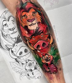 the lion king tattoo on someone's arm is shown in this photo, and it has