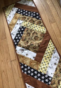 a close up of a wooden floor with a patchwork design on the bottom half