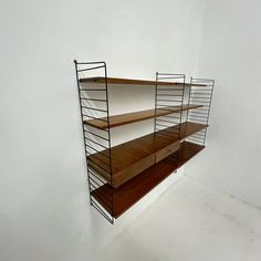 a shelf with three wooden shelves on each side and two metal shelving units in the middle