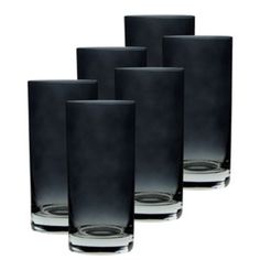 four black glass vases sitting next to each other