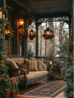 the porch is decorated for christmas with wreaths and lights